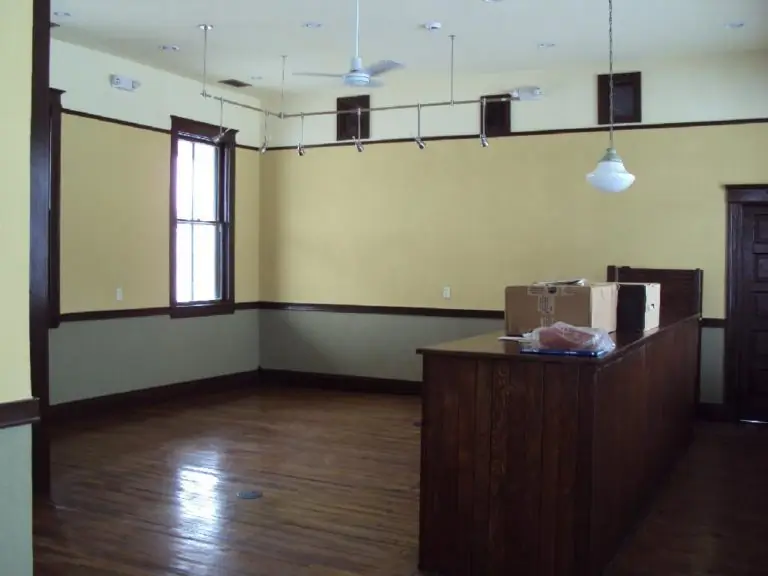 Restored depot interior with wood floors and a wooden counter