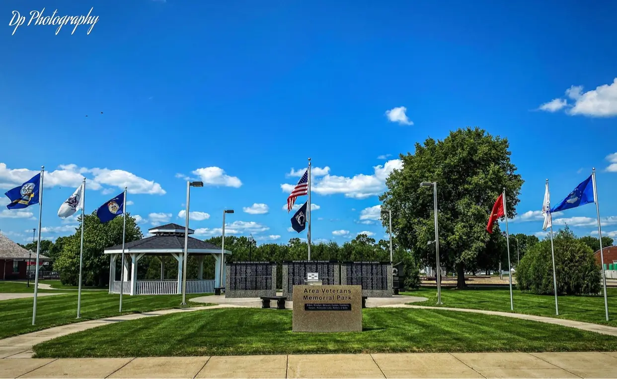 Area Veterans Memorial Park in Wells with memorial walls, flags, and a white gazebo.
